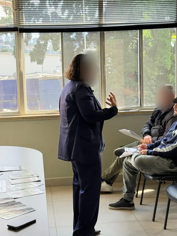 Instrutora conversando com participantes durante o treinamento